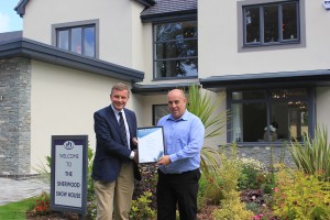 The Right Honourable David Jones, MP for Clwyd West, presents Steve with his Pride in the Job certificate at the Sherwood show house on Ravenscroft's Briarswood development in Colwyn Bay